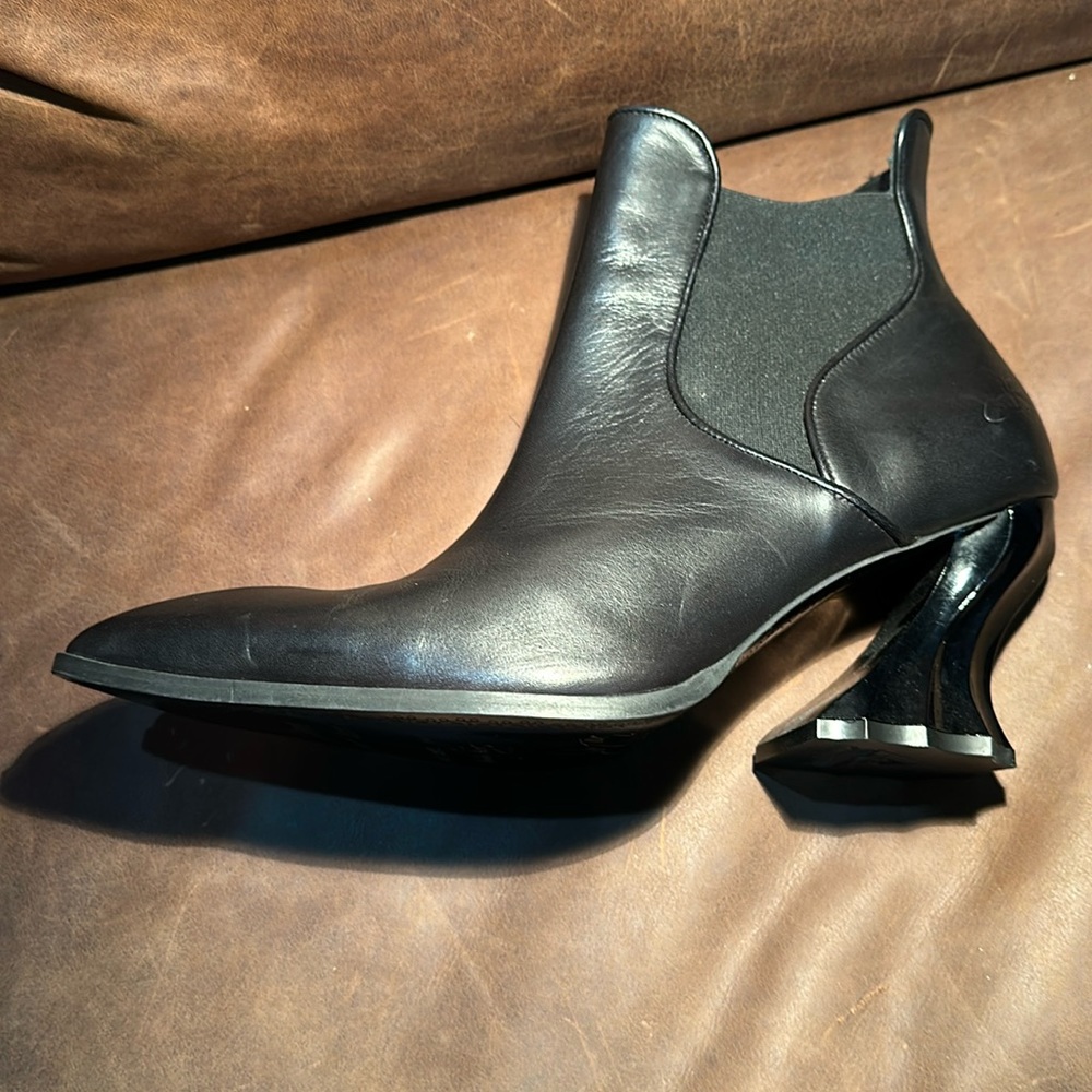 Dark Gothic dress boots with a pointed toe and sculptural heal.by FLUEVOG